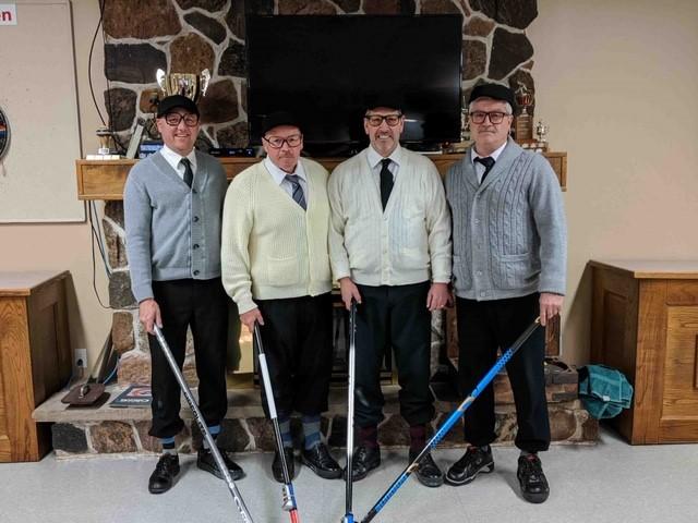 curling team dressed up in cardigans, glasses, socks, looking very dapper